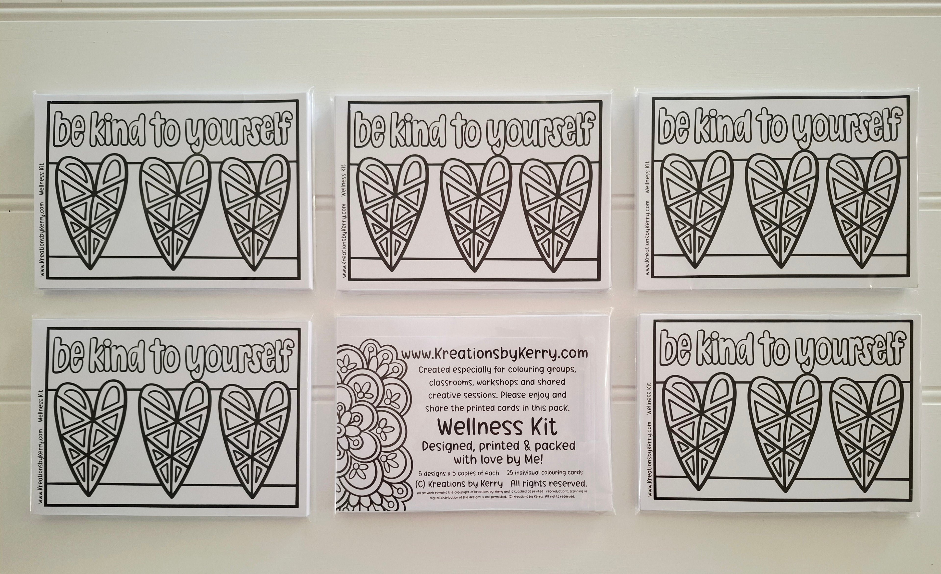 Six printable or physical cards arranged in two rows on a white wall. The top row shows three cards with the phrase 'be kind to yourself' above three outlined heart designs.